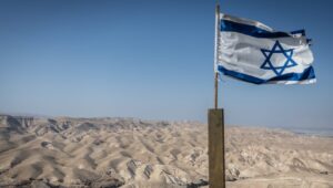 The Israeli flag with the Judean Desert, May 22, 2025. Photo by Chaim Goldberg/Flash90.