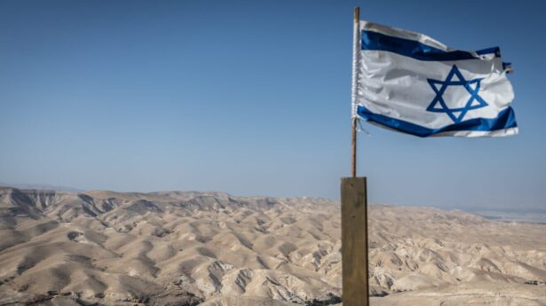 The Israeli flag with the Judean Desert, May 22, 2025. Photo by Chaim Goldberg/Flash90.