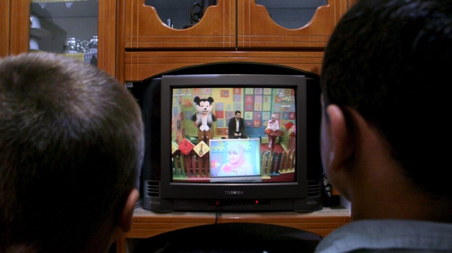 Palestinian children in Gaza City watch a children's program on al-Aqsa TV featuring a Mickey Mouse-like character named "Farfour" (Butterfly), who encourages children to become resistance fighters. Photo: EPA/MOHAMMED SABER