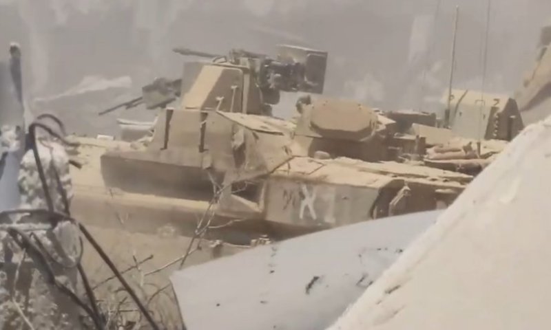 Screenshot from a Hamas propaganda video showing the exposed IDF Namer APC as terrorists rushed toward it for an "easy kill."