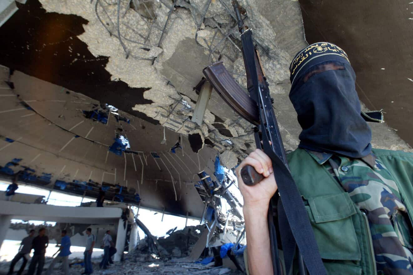 A Palestinian Islamic Jihad terrorist stands inside the ruins of the Netzarim community synagogue after the disengagement from the Gaza Strip, Sept. 12, 2005. Photo by Ahmad Khateib/Flash90.