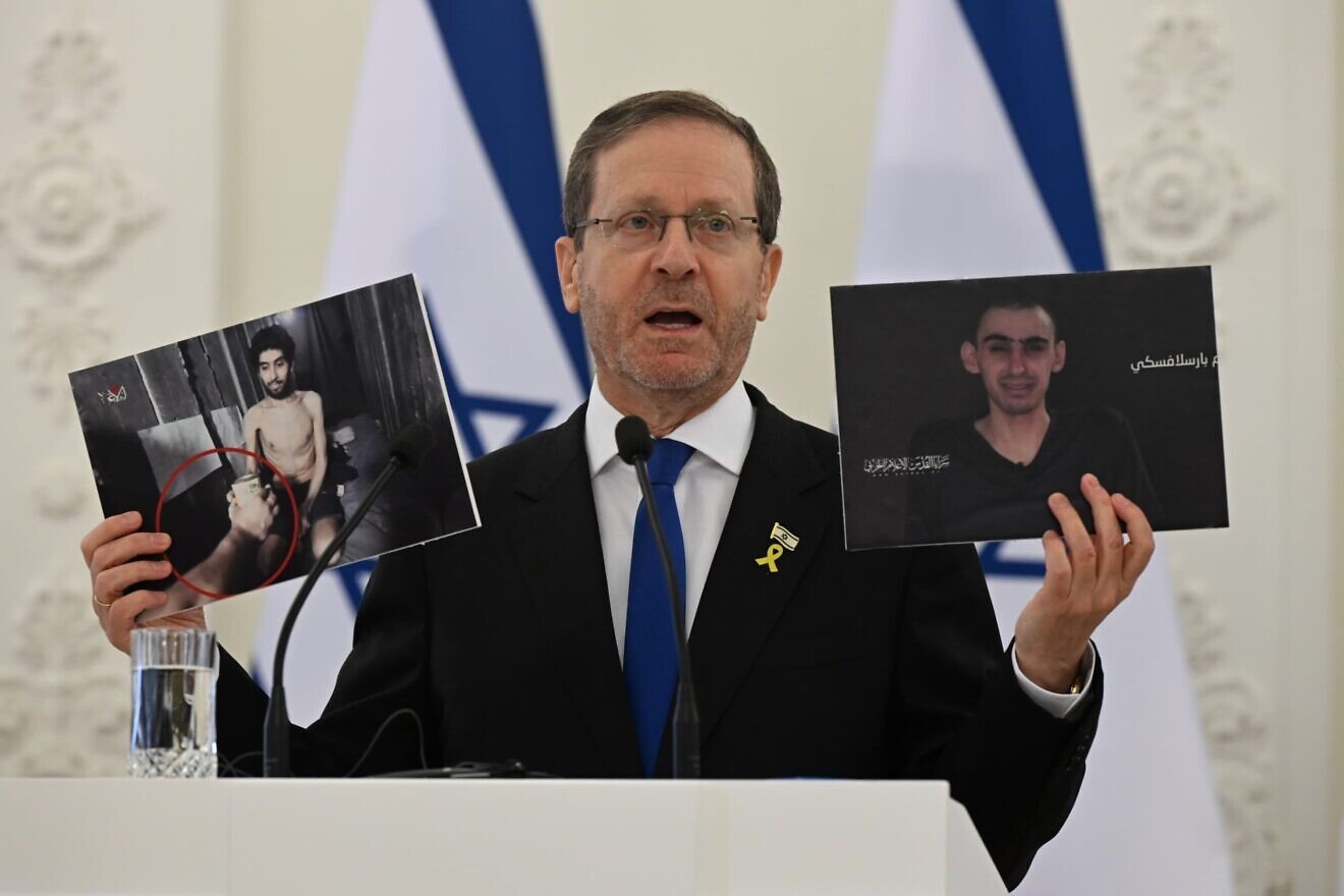 Israeli President Isaac Herzog holds up pictures of hostages Evyatar David and Rom Braslavski during a press conference in Vilnius, Lithuania, Aug. 4, 2025. Photo by Haim Zach/GPO.