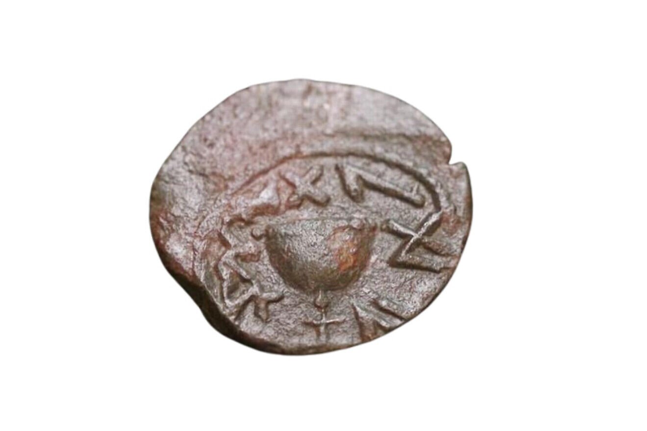 This bronze coin dating back two millennia to the Jewish Revolt against the Romans uncovered near the Temple Mount in Jerusalem features a chalice with an inscription in ancient Hebrew "For the Redemption of Zion." Credit: Emil Aladjem/IAA.