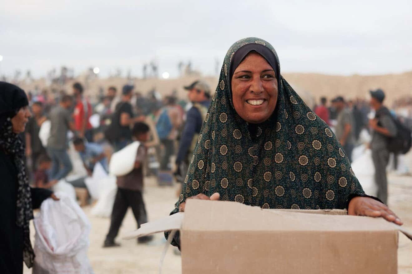A Palestinian woman receives a food package from the Gaza Humanitarian Foundation in Gaza, June 2025. Credit: Gaza Humanitarian Foundation.