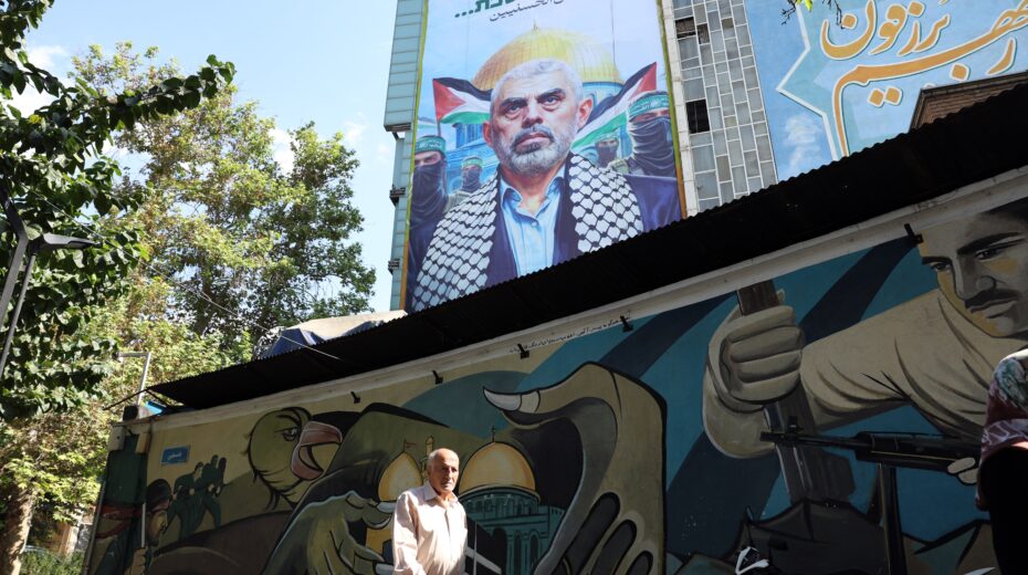 Iranians walk past a billboard depicting slain Hamas leader Yahya Sinwar in Palestine Square in Tehran, Iran, on October 19, 2024. Photo: EPA/ABEDIN TAHERKENAREH