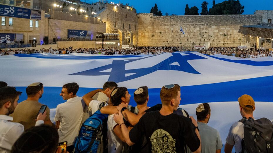 "A small people with a great God—Israeli flag in front of the Western Wall. Photo: Chaim Goldberg/Flash90