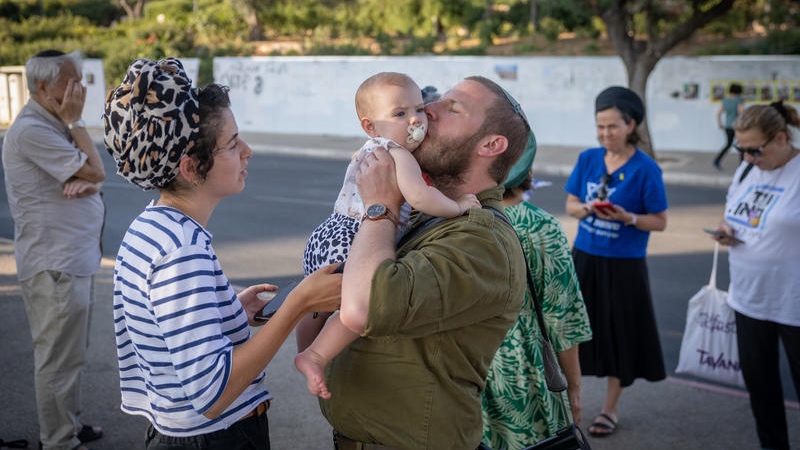 An IDF reservist says goodbye to his family as he departs again to battle Israel's enemies. Photo by Chaim Goldberg/FLASH90