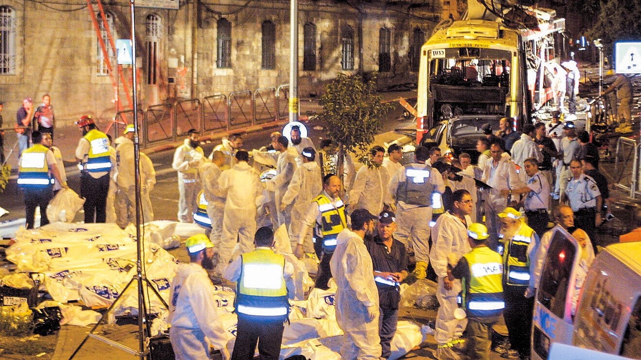 Rescue personnel and police at the scene of a suicide bombing attack in a crowded bus that killed 23 people and wounded more than 130 others in the Shmuel Hanavi neighborhood of Jerusalem on Aug. 19, 2003. Credit: Flash90.