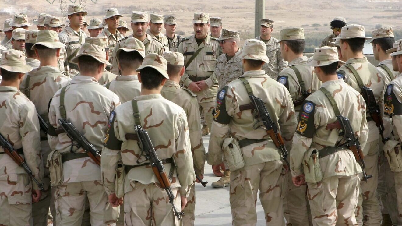 Azerbaijani soldiers circle around US Maj. Gen. Richard A. Huck, the commander of the 2nd Marine Division, during his visit to Camp Hadithah Dam, Al Anbar, Iraq, Jan. 2, 2006. Photo by Cpl. Adam C. Schnell/US Marine Corps via Wikimedia Commons.