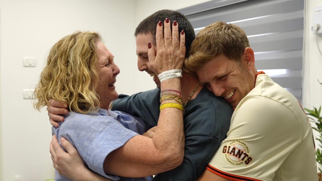 The family of Elkana Bohbot embrace him after two years in Hamas captivity. Photo: IDF Spokesman