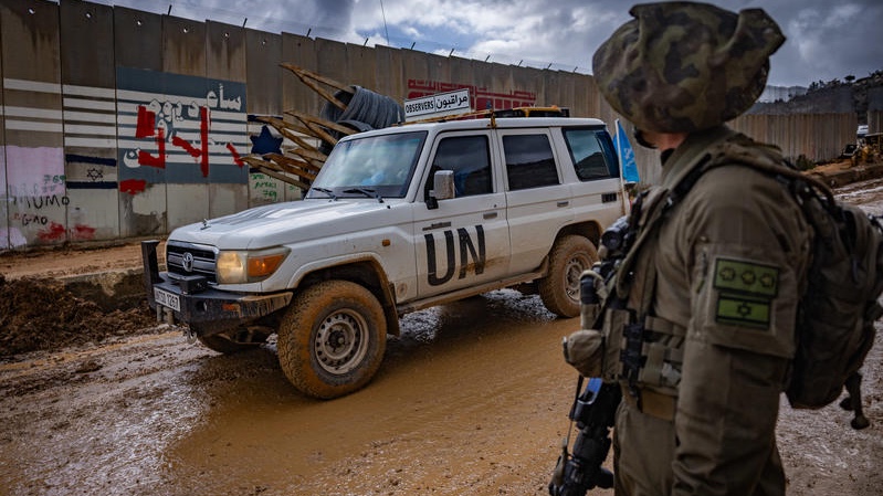 An Israeli soldier looks on while UN peacekeepers (UNIFIL) patrol in Kfarkela, in southern Lebanon, February 13, 2025. Photo by Yonatan Sindel/Flash90