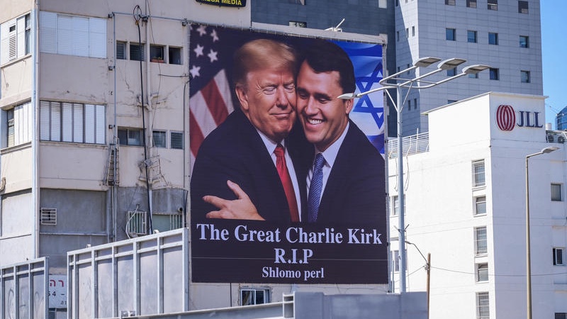 A large banner showing US President Donald Trump embracing Charlie Kirk, who was assassinated, hangs on a building near the Ayalon Highway in Tel Aviv. The banner was placed overlooking one of Israel’s busiest roads as a tribute to the slain activist, September 12, 2025. Photo by Avshalom Sassoni/Flash90