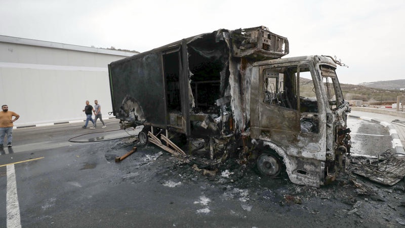 Palestinians inspect burned trucks and cars following an attack by Israeli settlers in the village of Beit Lid, east of Tulkarm, in the West Bank, on November 11, 2025. Photo by Nasser Ishtayeh/Flash90