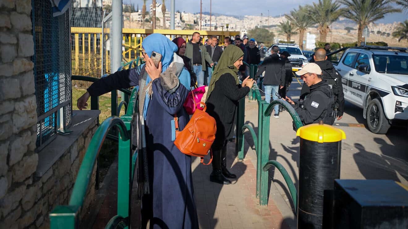 Palestinian workers line up at the entrance to the Israeli city of Ma'ale Adumim in Judea following an attempted stabbing attack, Feb. 23, 2023. Photo by Jamal Awad/Flash90.