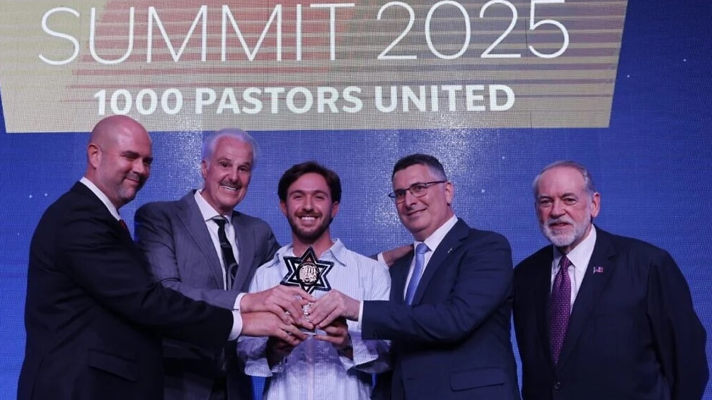 Former Israeli hostage Omer Shem Tov receives an award at a gathering of American pastors and Christian leaders in Israel, flanked by, from left: Knesset Speaker Amir Ohana, evangelical leader Mike Evans, Israeli Foreign Minister Gideon Sa'ar and U.S. Ambassador Mike Huckabee, Dec. 3, 2025. Photo by Yossi Zamir.