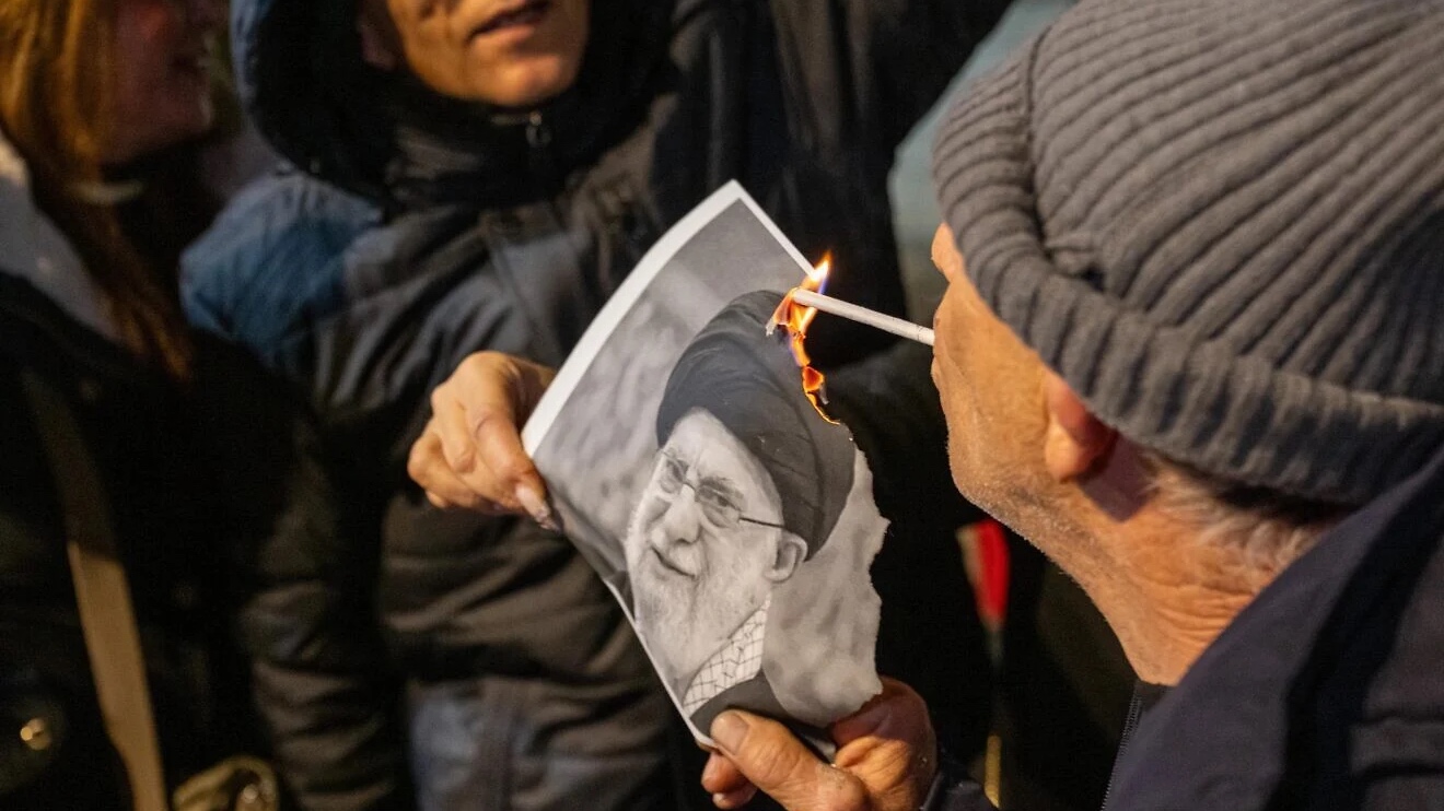 Members of the Iranian Jewish community light photos of Ali Khamenei during a "Free Iran" rally in Holon, Israel, Jan. 14, 2026. Photo by Matt Kaminsky/JNS.