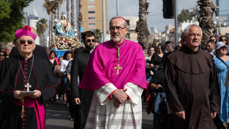 Latin Patriarch Pierbattista Pizzaballa and Catholic Christians march as they take part in a procession of the Virgin Mary in Haifa, May 1, 2022. Photo by Shir Torem/Flash90