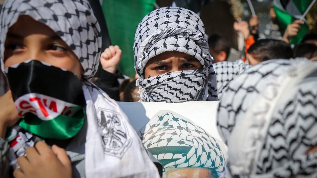 Palestinian children in Hebron hold placards with a portrait of former PLO chief Yasser Arafat during a rally by Fatah Party supporters marking the 21th anniversary of his death, Nov. 11, 2025. Photo by Wisam Hashlamoun/Flash90.