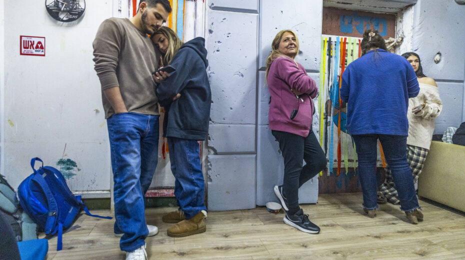Israelis wait in a public bomb shelter in Mazkeret Batya during a rocket alert. In a reality of constant uncertainty, people continue to plan their lives – well aware of how quickly everything can change. Photo: Yossi Aloni/Flash90