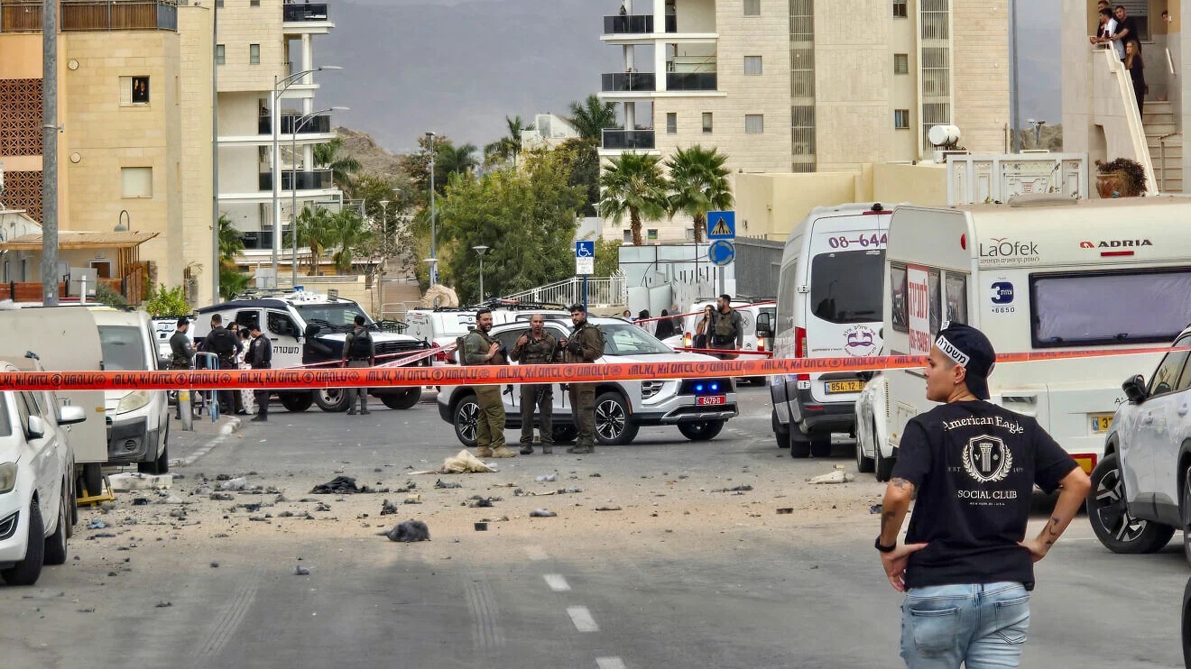 People inspect the damage at the scene where an Iranian missile wounded two civilians and damaged property in Eilat, southern Israel, on March 14, 2026. Photo by Yehuda Ben Itach/Flash90.