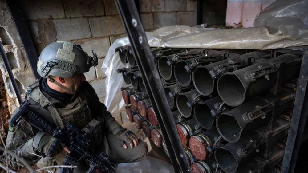 An Israeli soldier examines anti-tank ordnance seized from Hezbollah’s Radwan Force in Southern Lebanon, Dec. 28, 2024. Credit: IDF.