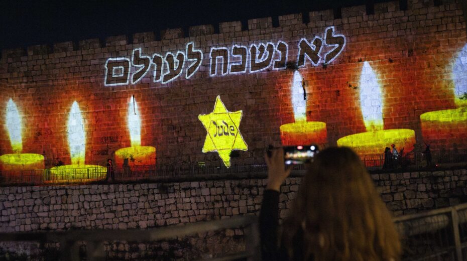 On Yom HaShoah, candles and a yellow star are projected onto the walls of Jerusalem's Old City – in remembrance of the six million murdered Jews. Photo: Yonatan Sindel/Flash90