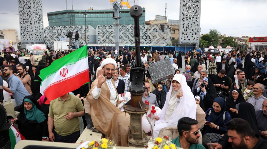 A Shiite cleric and his bride travel in a military jeep to a public mass wedding in Imam Hossein Square in Tehran, May 18, 2026. Photo: EPA/ABEDIN TAHERKENAREH