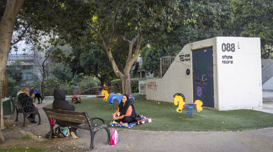 People sit in front of a public shelter in Haifa, March 10, 2026. Photo: Yossi Aloni/Flash90.