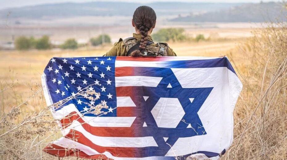 An Israeli soldier holds a combined U.S-Israeli flag ahead of Yom Ha’atzmaut, Israeli Independence Day, April 2026. Credit: IDF Spokesperson’s Unit.