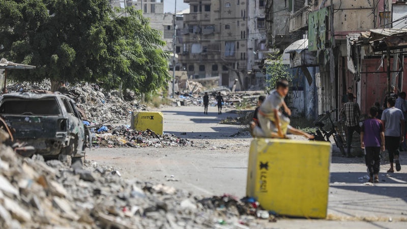Palestinians walk next to yellow concrete block marking the “yellow zone” under Israeli military control in the Tufah neighborhood of Gaza City, July 27, 2026. Photo by Ali Hassan/Flash90