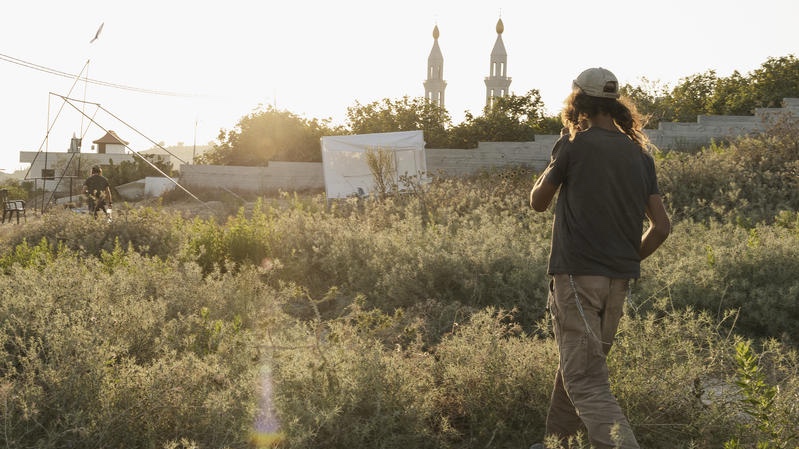 A Jewish "settler" walks near a Palestinian Arab village in Samaria. Photo by Hilel Ben Or/Flash90
