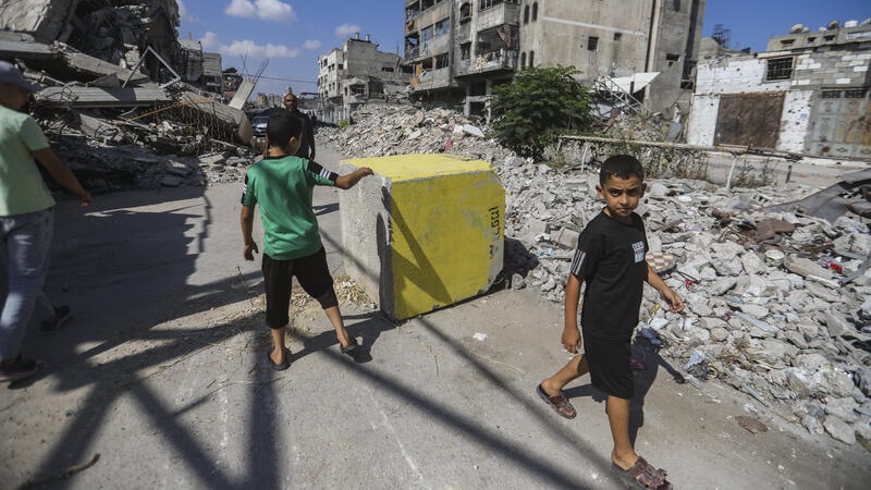 Palestinians walk next to yellow concrete block marking the “yellow zone” under Israeli military control in the Tufah neighborhood of Gaza City, July 27, 2026. Photo by Ali Hassan/Flash90