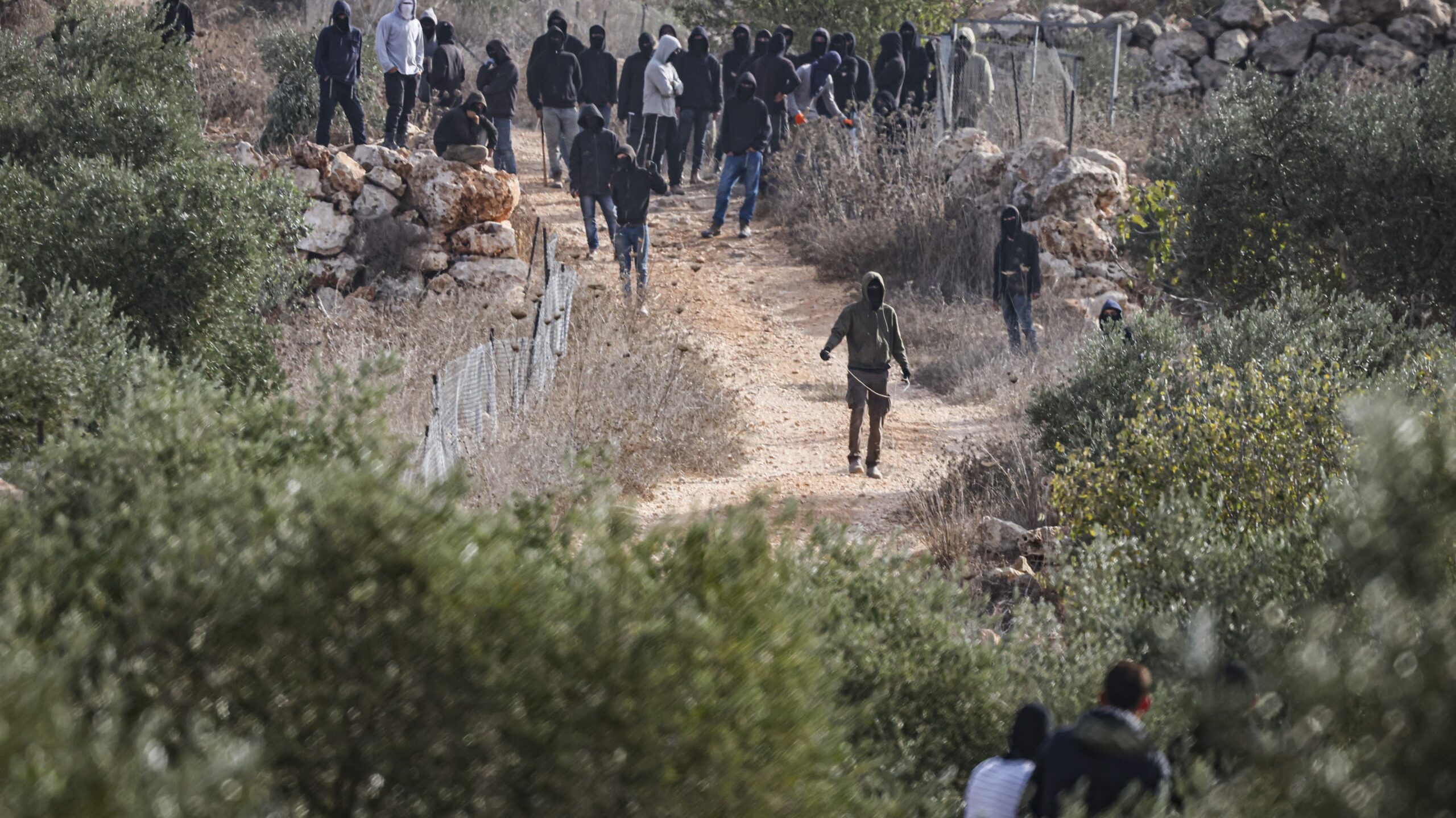 Masked Jewish settlers during the violent clashes with Palestinians during the olive harvest near Abu Falah in Judea and Samaria, October 16, 2026. Photo: Flash90